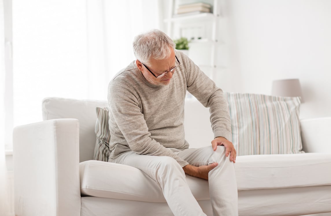 Senior Man Suffering from Knee Ache at Home